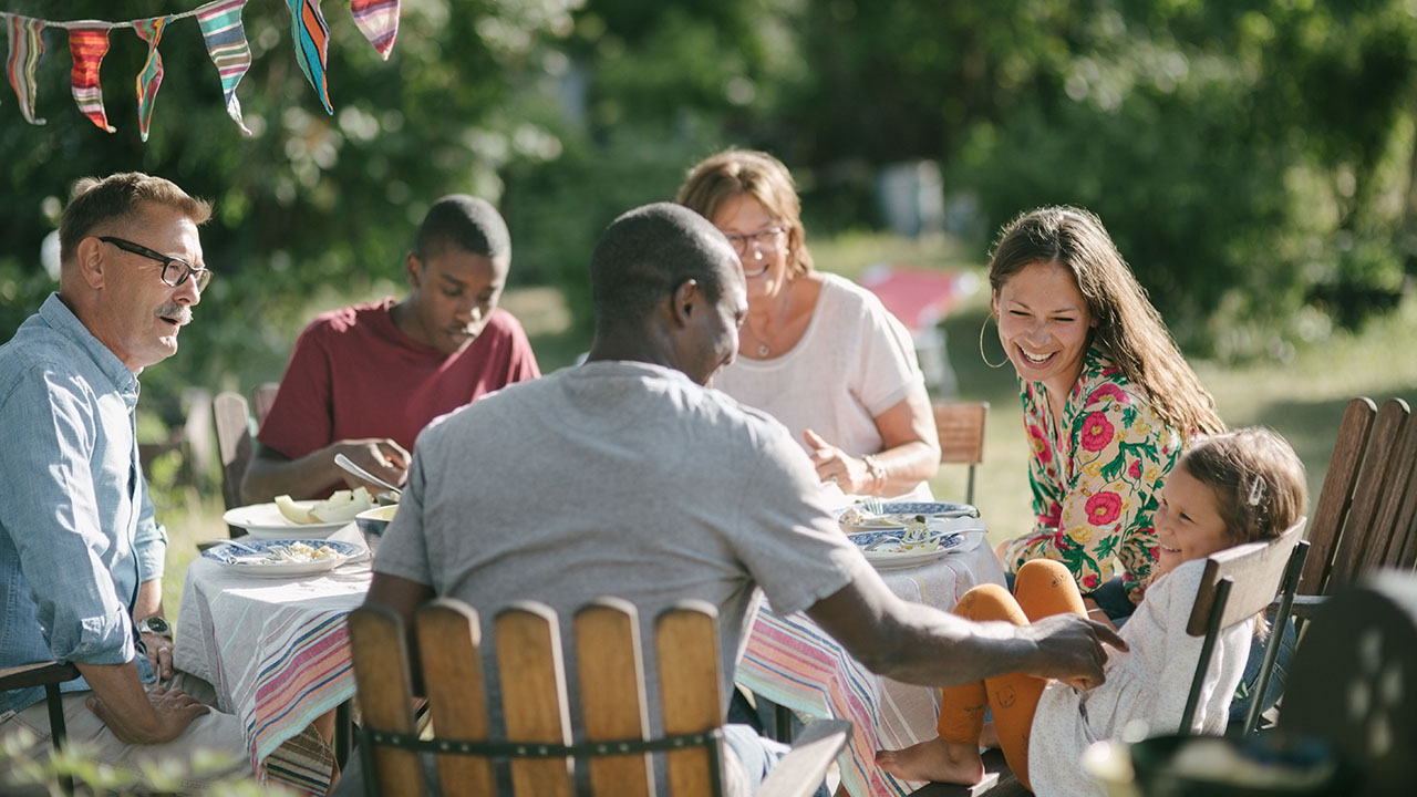 Family hving dinner at their backyard
